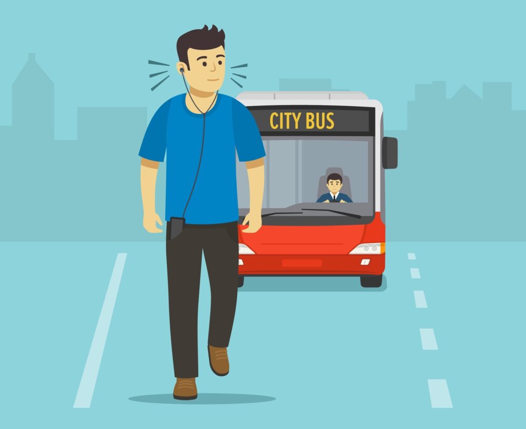 A young man, listening to loud music, walking on the road unaware of an approaching city bus, putting him in imminent danger.