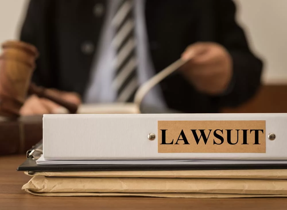 Legal consultation with a lawyer working on a lawsuit document at a law firm in Miami, FL.