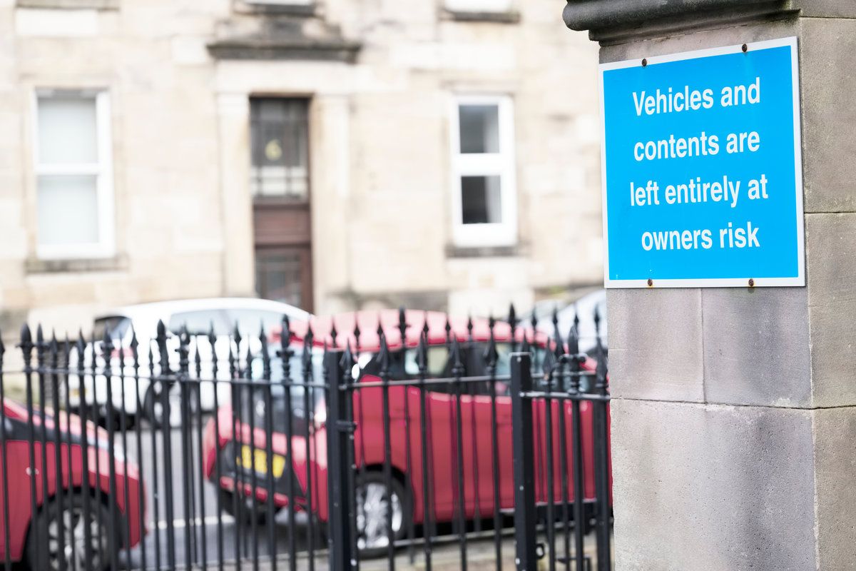 Vehicles and contents left entirely at owners risk and liability sign and cars in background